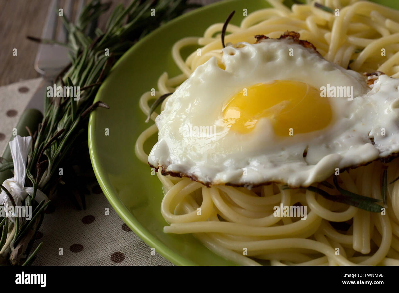 Spaghetti mit Spiegelei und Rosmarin auf grüne Platte selektiven Fokus Stockfoto