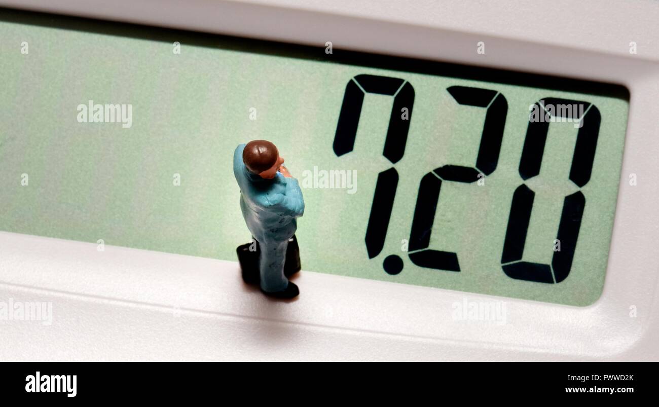 Ein Miniatur-Business-Mann stehend auf einem Rechner mit der neuen existenzsichernden Lohn £7,20 auf dem Bildschirm Stockfoto