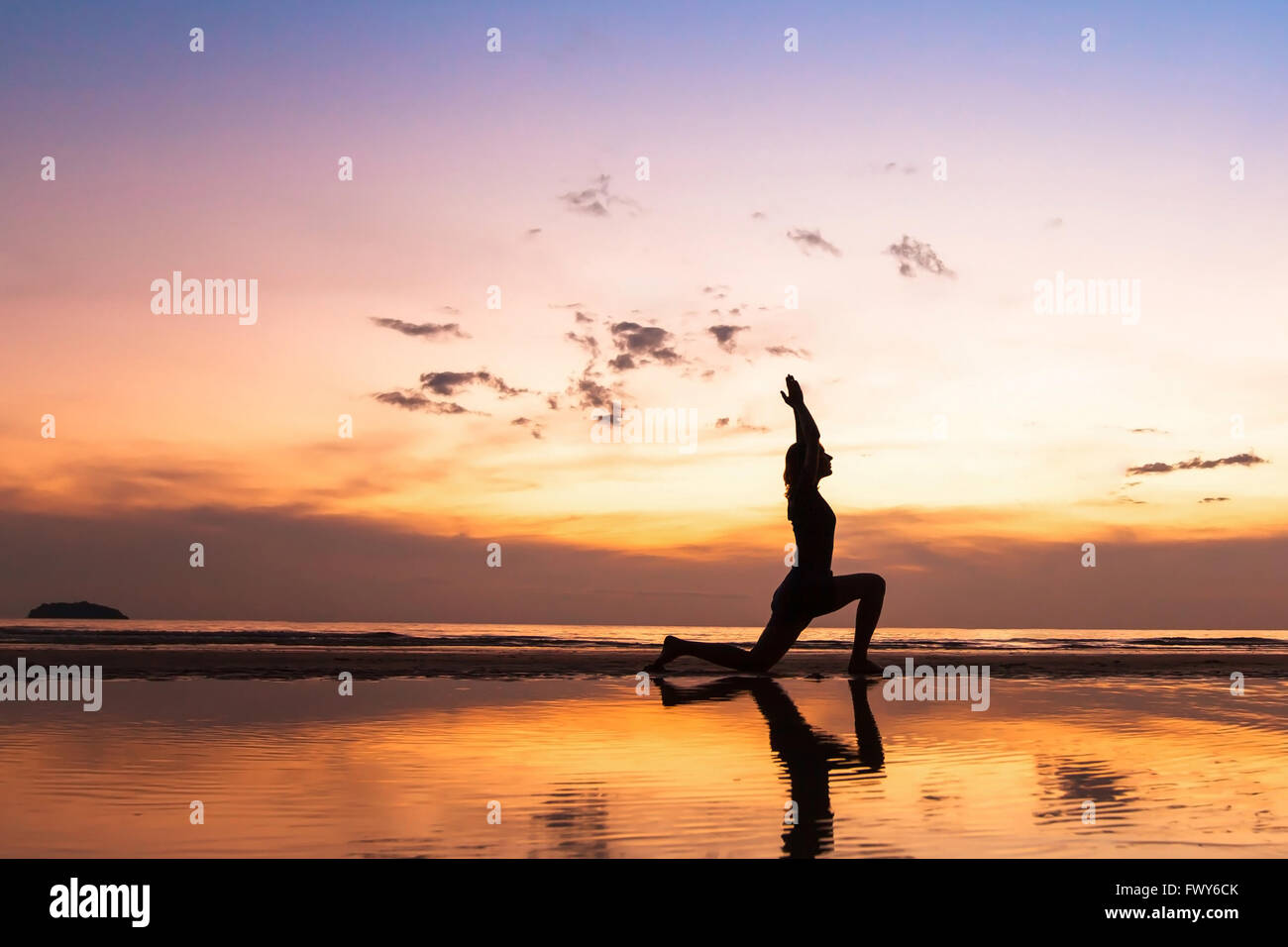 schöne Yoga üben am Strand bei Sonnenuntergang, Hintergrund mit Exemplar Stockfoto