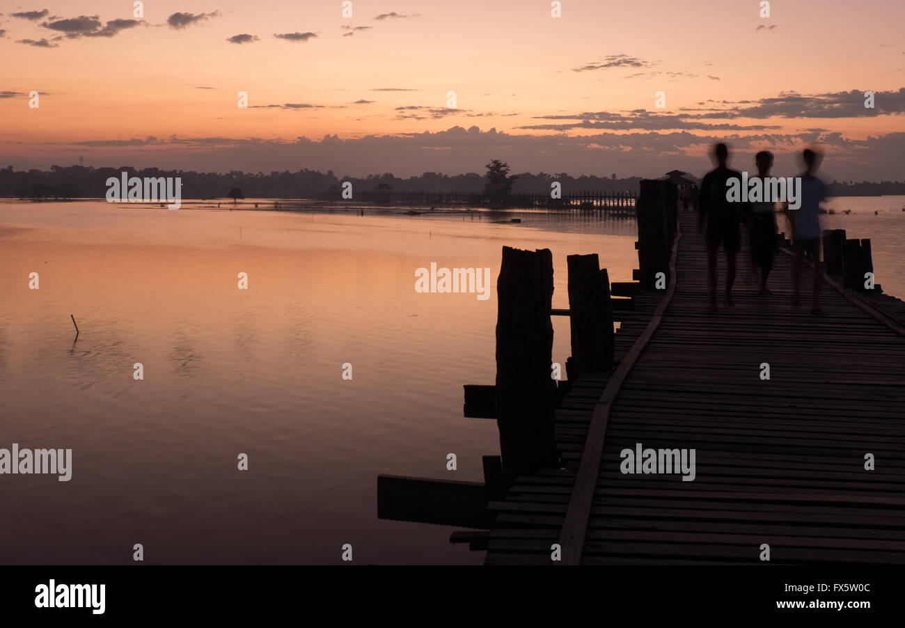 Drei junge Burschen in der Morgendämmerung über U Bein Brücke zu Fuß Stockfoto