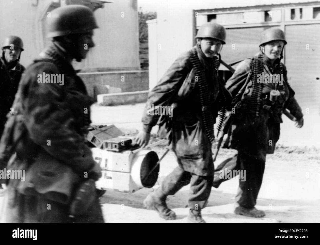 Das Propagandafild der Nazis zeigt Mitglieder des SS-Parachute-Bataillons von 500. mit Munition während der Eroberung der Stadt Drvar in Jugoslawien. Das Foto wurde Ende Mai/Anfang Juni 1944 aufgenommen. Das Ziel der so genannten „Operation Roesselsprung“ war die Zerstörung des Hauptquartiers der jugoslawischen Partisanen und die Gefangennahme ihres Anführers Josip Broz Tito. Fotoarchiv für Zeitgeschichtee - KEINE ÜBERWEISUNG - Stockfoto
