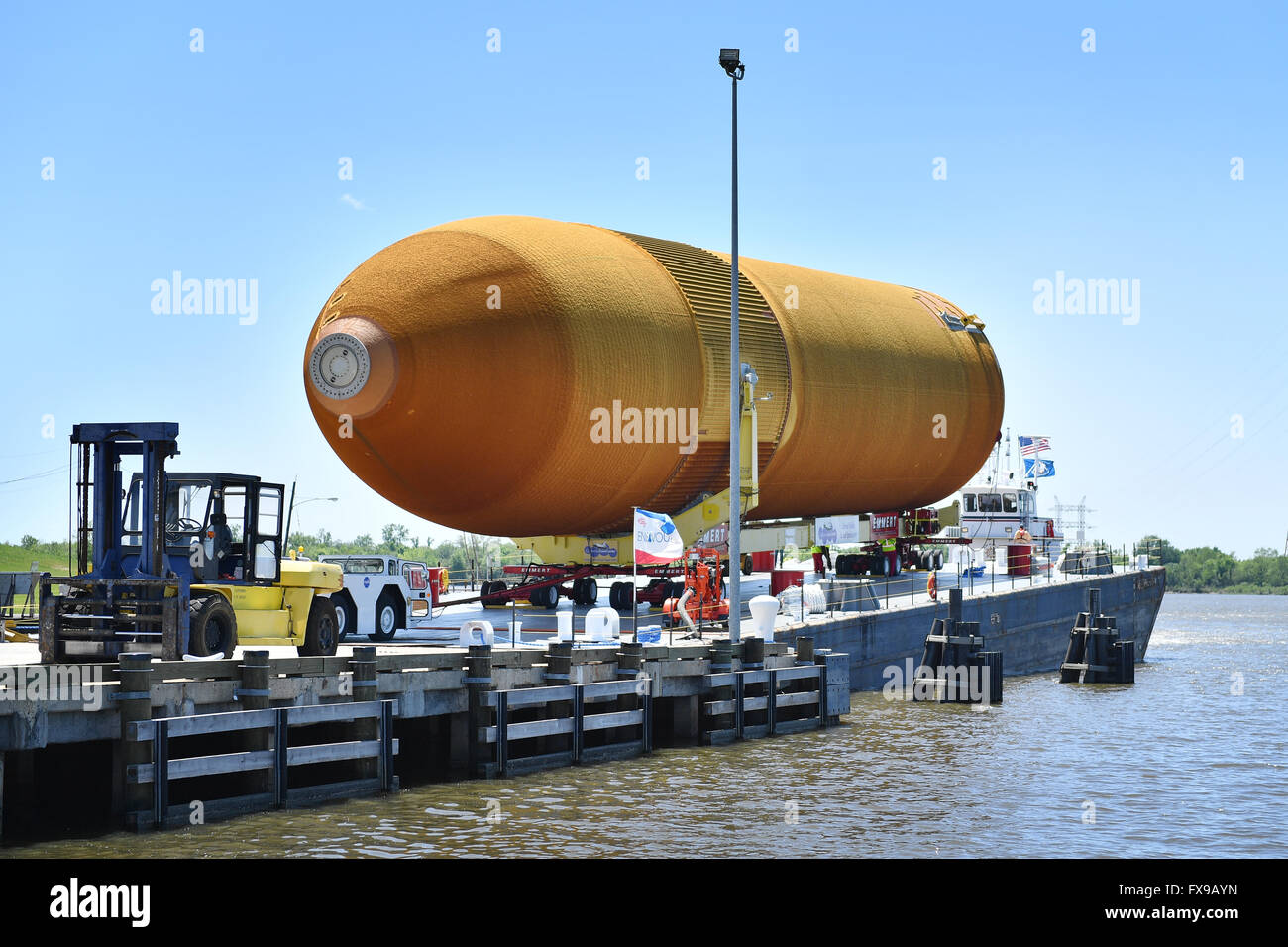 New Orleans, Louisiana, USA. 12. April 2016. Die letzte Space Shuttle external Fuel Tanks beginnt einen langen Weg bis der California Science Center, wie es auf einem Lastkahn an der Michoud Assembly Facility 12. April 2016 in New Orleans, Louisiana verschoben wird. Die massive 154 Fuss lang, 69.000 Pfund Struktur einmal die Raumfähre Hauptmotoren flüssiger Sauerstoff und flüssiger Wasserstoff zugeführt und wurde mit dem Shuttle-Programm eingestellt wurde. Bildnachweis: Planetpix/Alamy Live-Nachrichten Stockfoto