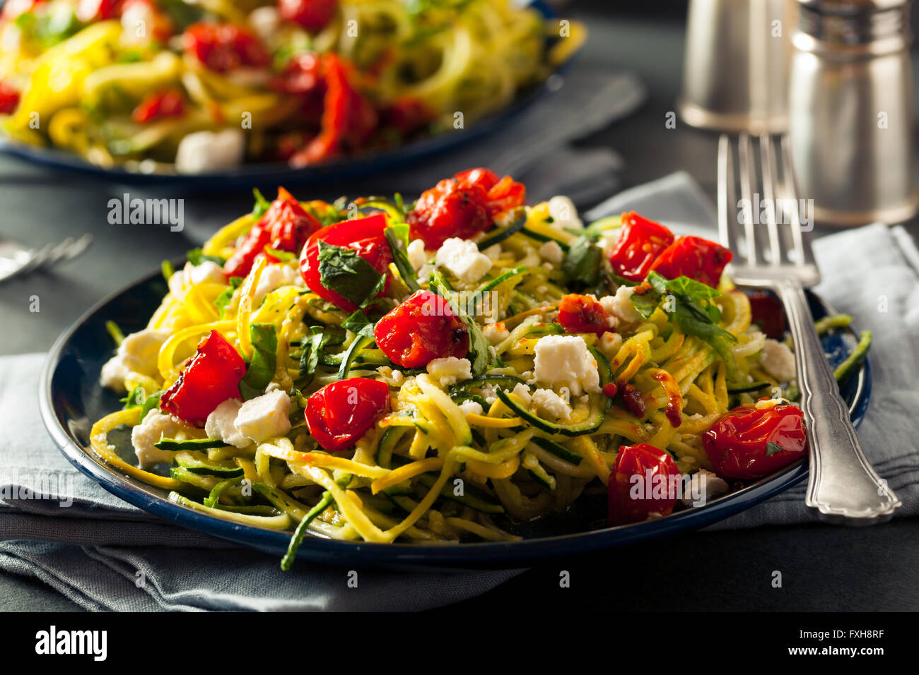 Hausgemachte Zucchini Nudeln Zoodles Pasta mit Tomaten und Feta Stockfoto