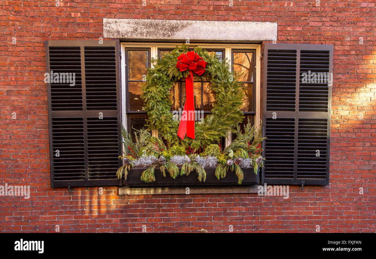 Kranz aufhängen aus einem Fenster mit Fensterläden in einem roten Backsteingebäude Acorn St, Beacon Hill, Boston, USA Stockfoto