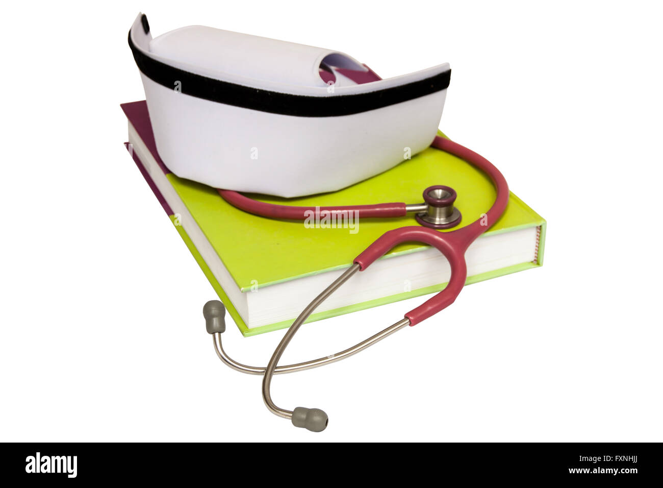 Eine isolierte Krankenschwester Hut auf Lehrbuch und Stethoskop Stockfoto