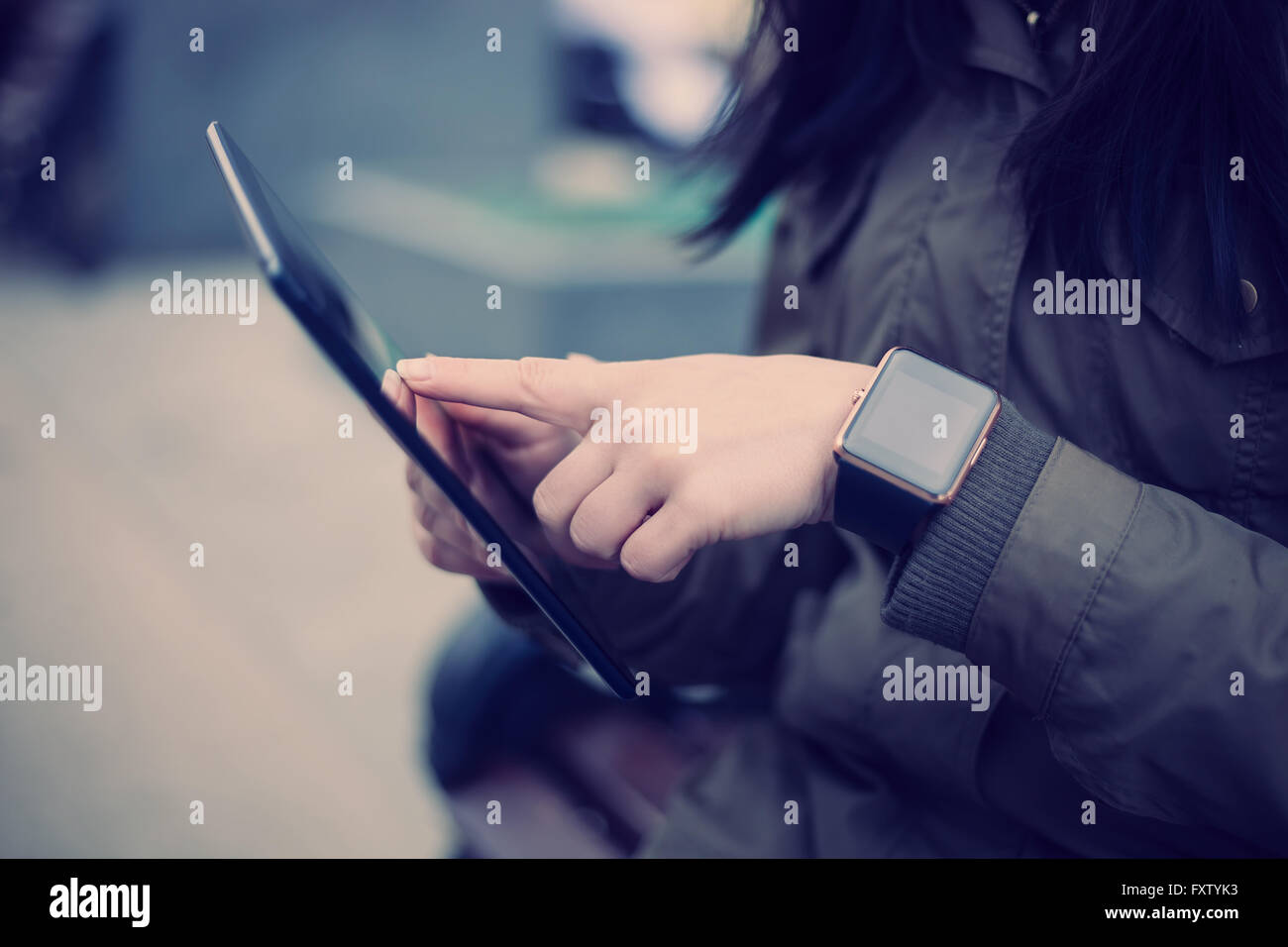 Frau mit Tablet-pc beim smart-Uhr an ihrem Handgelenk tragen. Dieser neue Geräte können Sie immer in Verbindung mit Internet und social Media Netzwerke aus wohin Sie wollen bleiben. Stockfoto