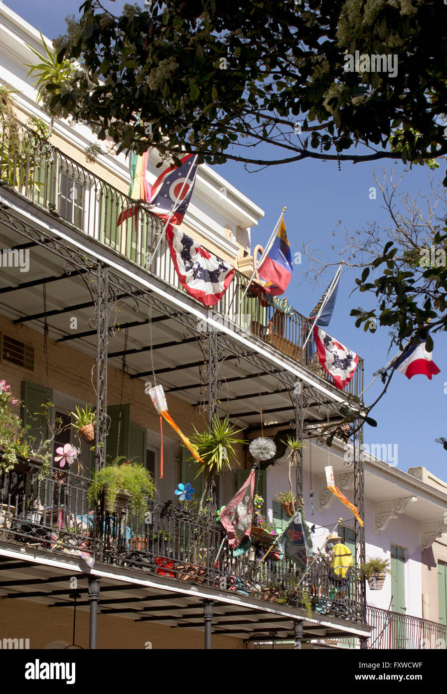 New Orleans French Quarter Balkon geschmückt mit mehreren Flaggen und Wind Socken. Stockfoto
