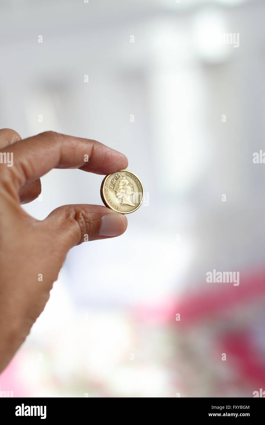 Schließen Sie herauf Bild der linken Hand, die australische Münze $2 Stockfoto
