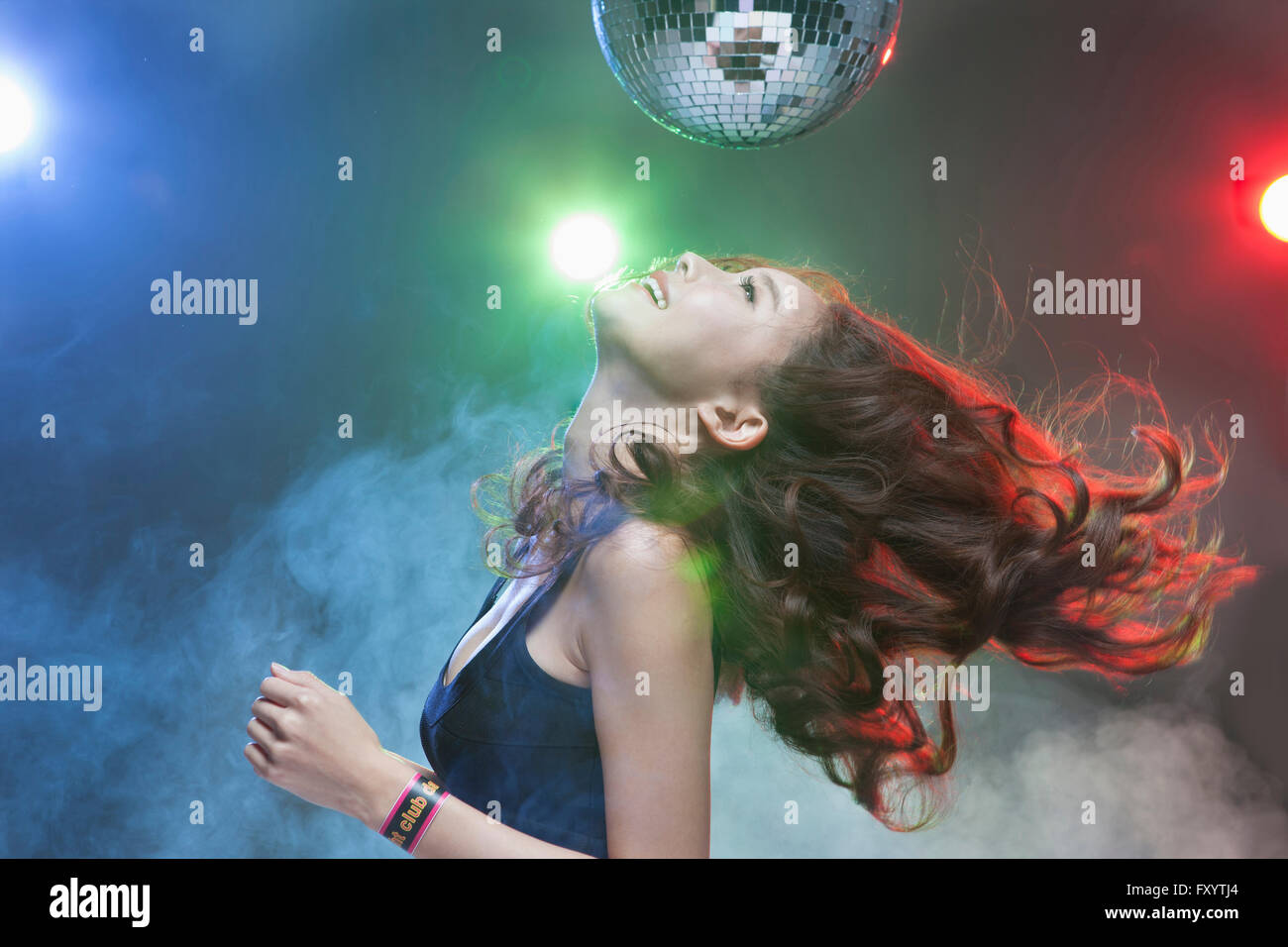 Seite Ansicht Porträt des jungen lächelnde Frau tanzen suchen oben im Nachtclub Stockfoto