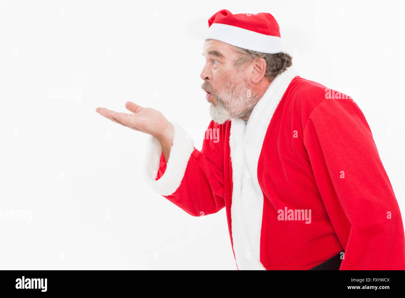 Seite Ansicht Porträt von Santa hält seine Hand und bläst Stockfoto