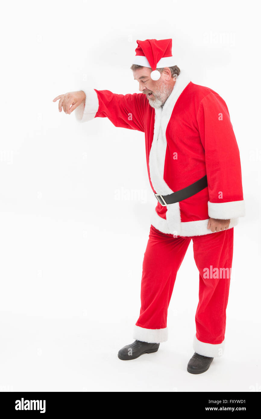 Seitenansicht des Lächelns Santa stehend und hält seine Hand nach unten Stockfoto