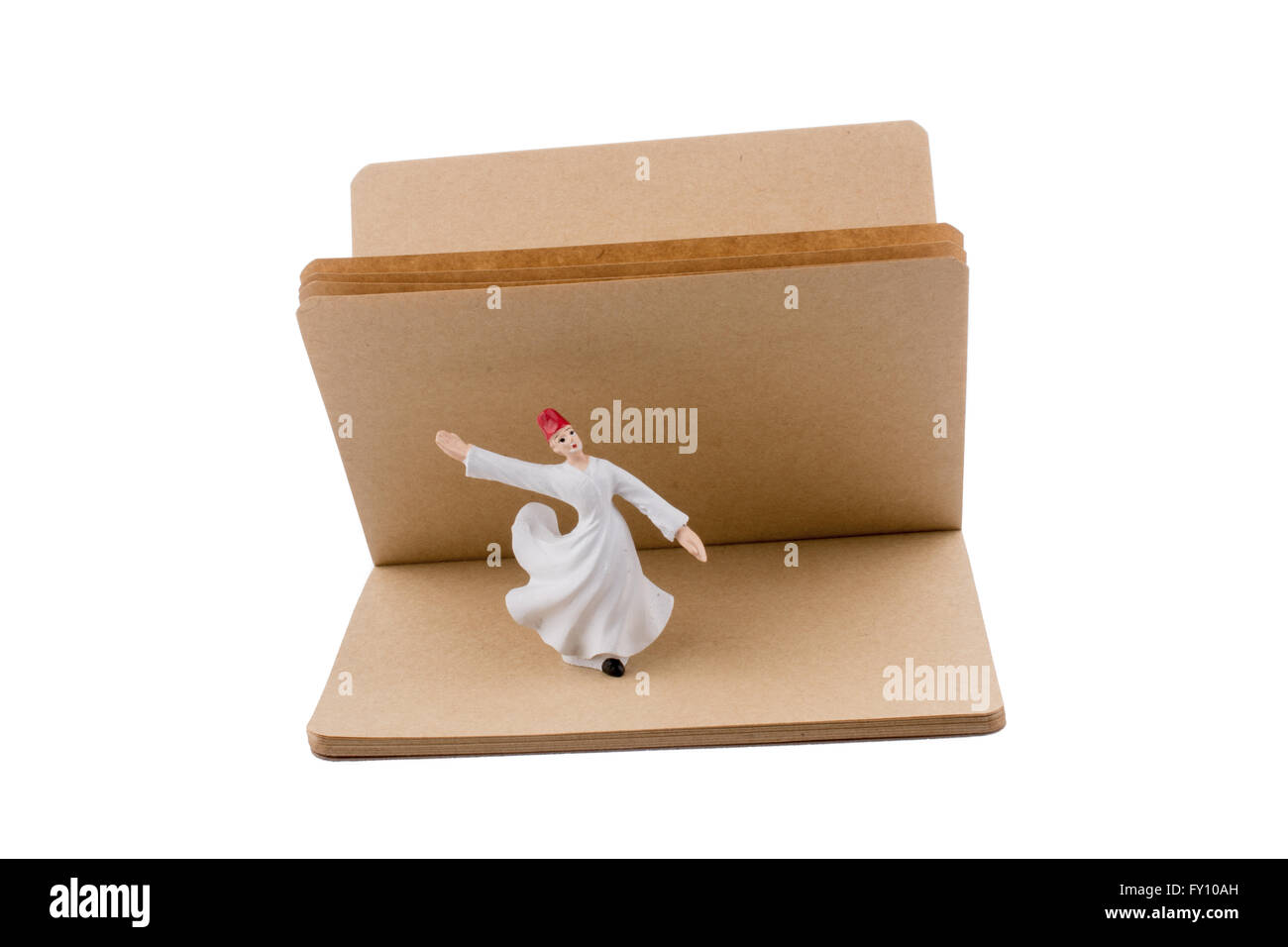 Sufi Derwisch auf einem Notebook auf weißem Hintergrund Stockfoto