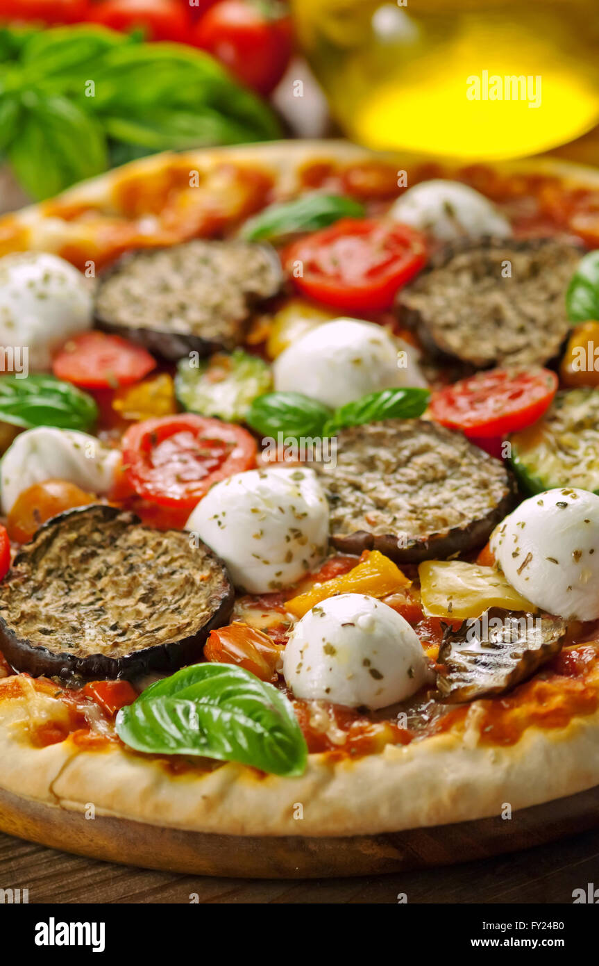 Vegetarische Pizza mit frischen Zutaten auf Holzplatte Stockfoto