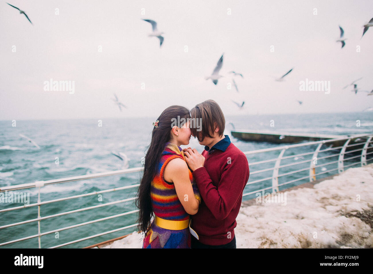 -Liebhaber auf der Pier und Möwen im Hintergrund. Romantische Hochzeitsreise Stockfoto
