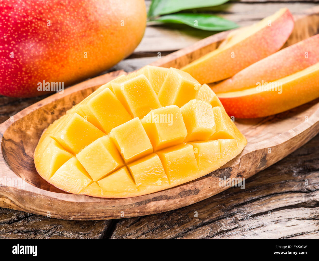 Mango-Frucht und Mango Würfel auf dem Holztisch. Stockfoto