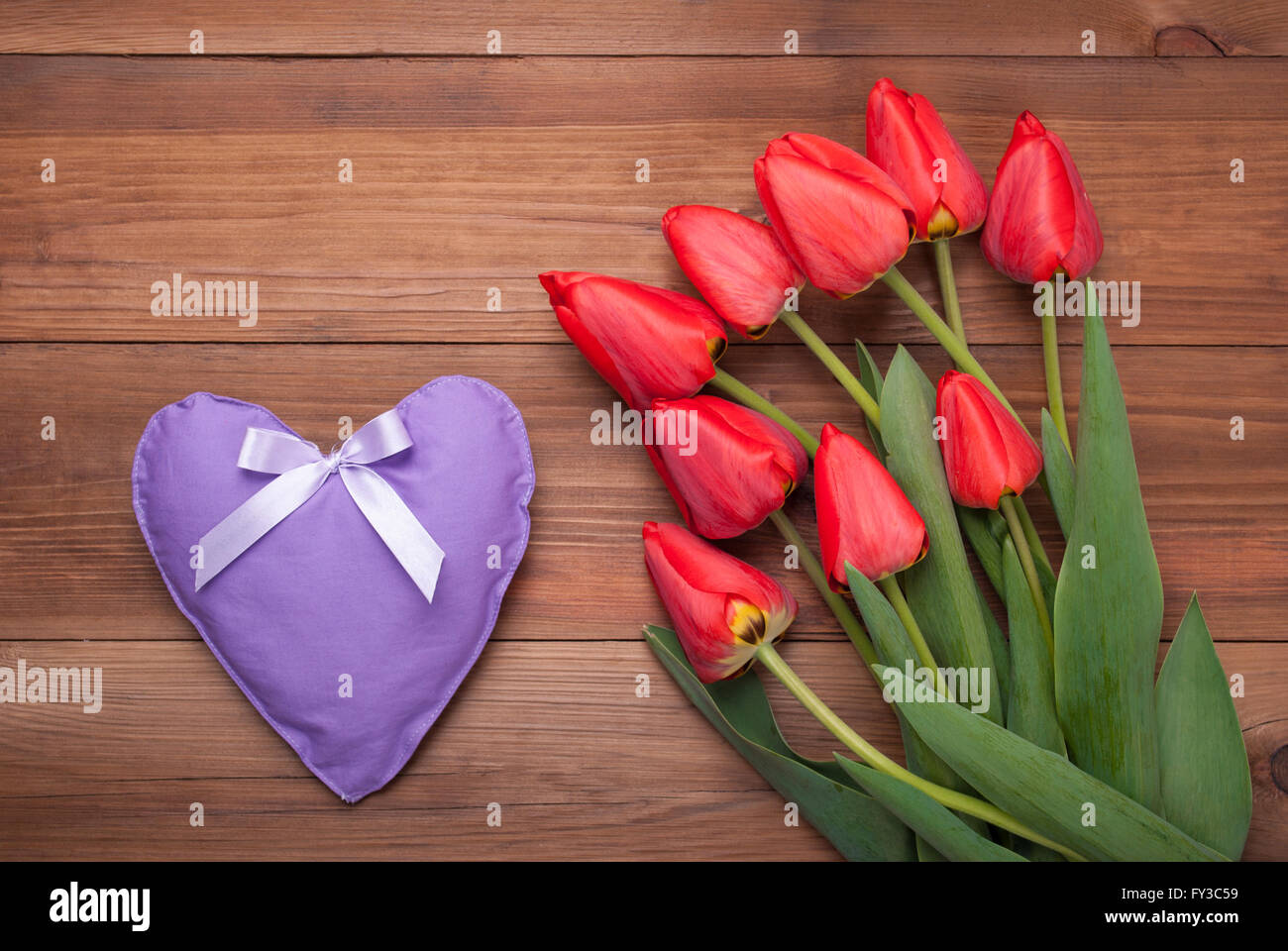 Tulpen auf Holzbrettern und Herz zu legen. Stockfoto
