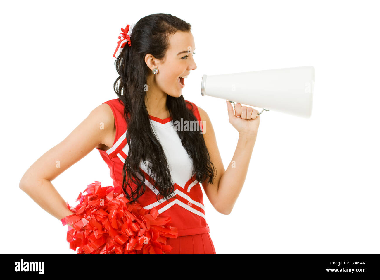 Süße Frau wie eine amerikanische Sportarten Cheerleader in roten und weißen Outfit.  Isoliert auf weißem Hintergrund. Stockfoto