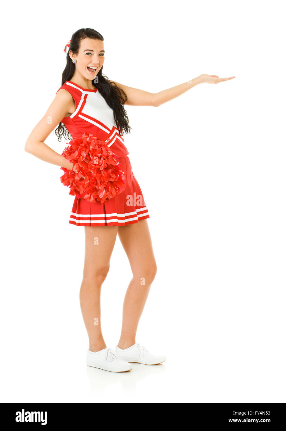 Süße Frau wie eine amerikanische Sportarten Cheerleader in roten und weißen Outfit.  Isoliert auf weißem Hintergrund. Stockfoto