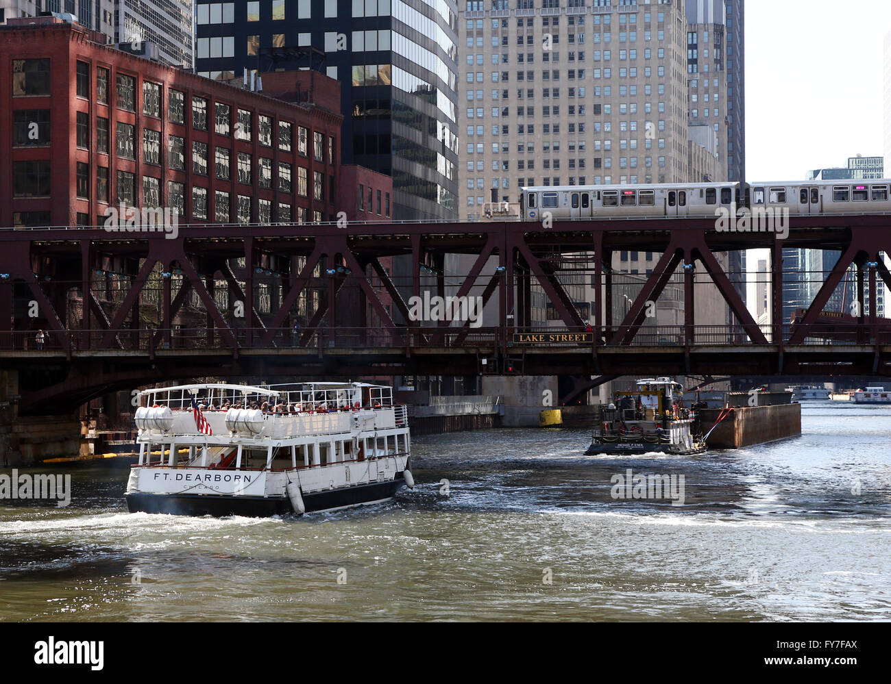 Ein Kreuzfahrtschiff Architektur und Kahn auf dem Chicago River unter einem erhöhten CTA trainieren an der Lake Street Bridge in Chicago Stockfoto