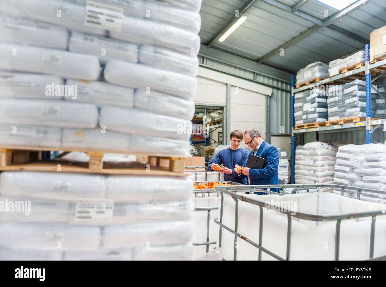 Manager und Arbeiter im Lager Kunststoff Fabrik prüfen Produkte Stockfoto