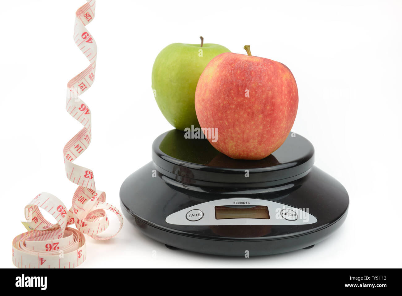 Schwarzen Digitalwaage auf isolieren weißen Hintergrund, mit grünem Apfel, Maßband Stockfoto
