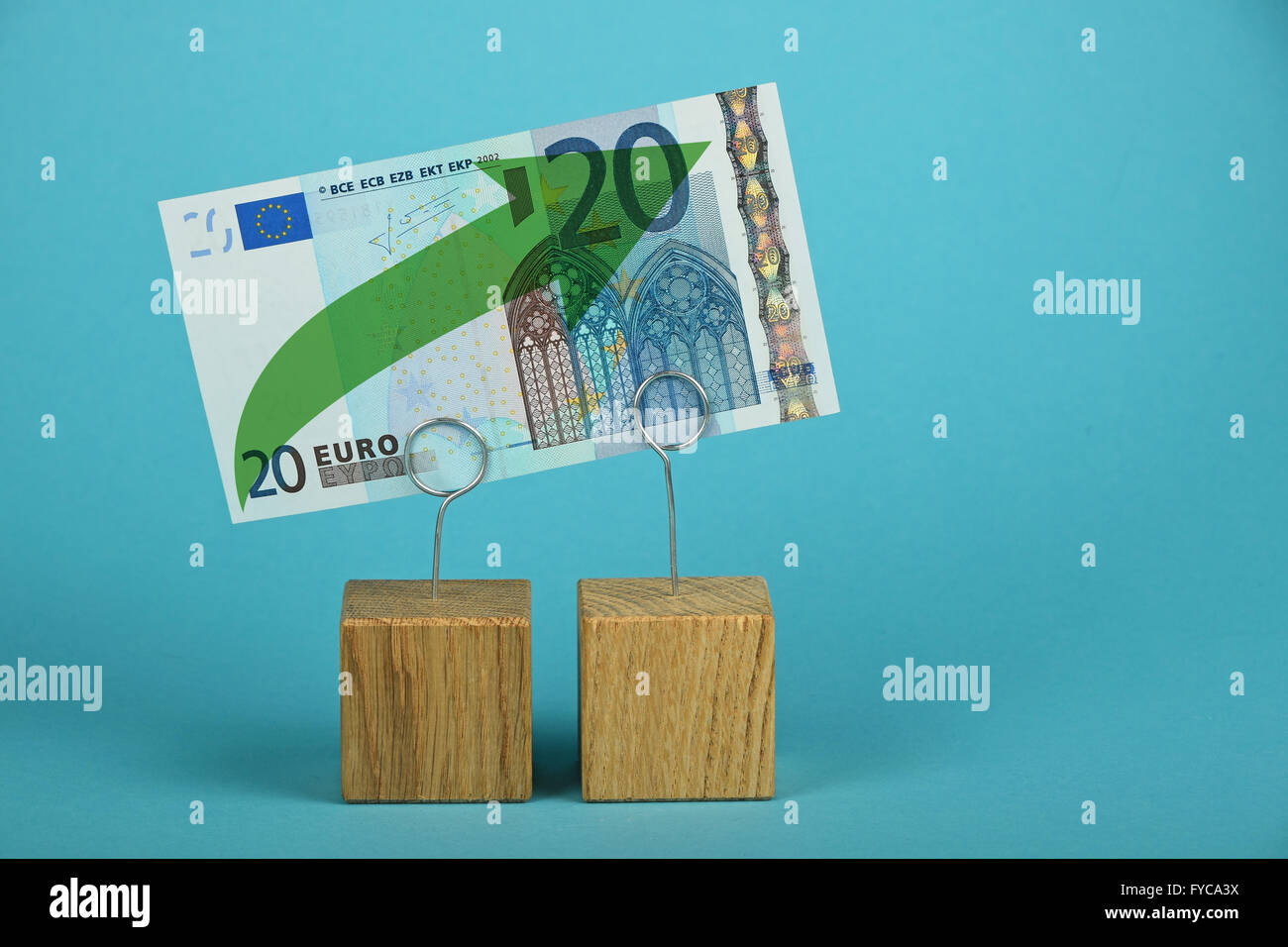 Wachstum und Unterstützung der europäischen Wirtschaft und Euro, 20 Euro-Banknote mit grünen Pfeil nach oben auf zwei Haltern auf blauem Hintergrund Stockfoto