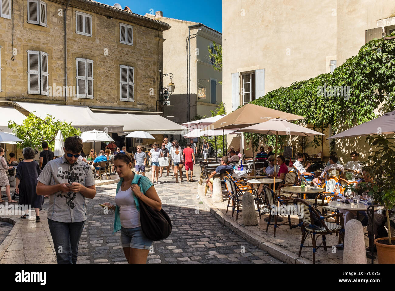 Touristen auf der Straße von Lourmarin, Luberon, PACA, Frankreich (Lourmarin ist als eines der schönsten Dörfer Frankreichs aufgeführt) Stockfoto