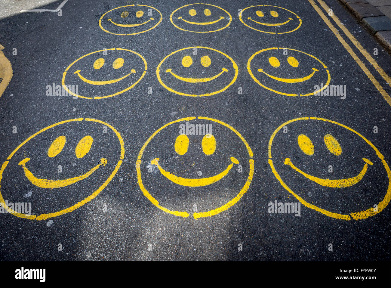Smiley-Gesichter auf der Straße in Brighton gemalt. Stockfoto