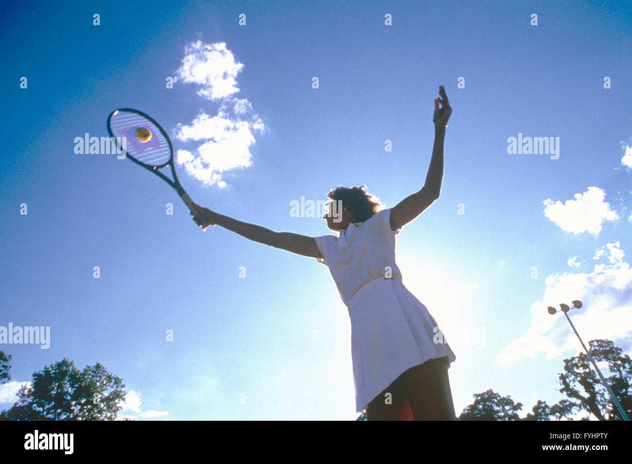 Tennisspielerin, die den Ball mit einem Schläger Stockfoto