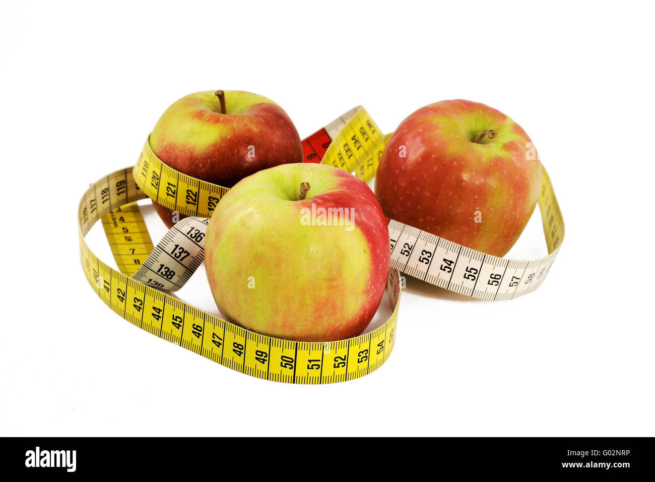 drei Äpfel mit Maßband Stockfoto