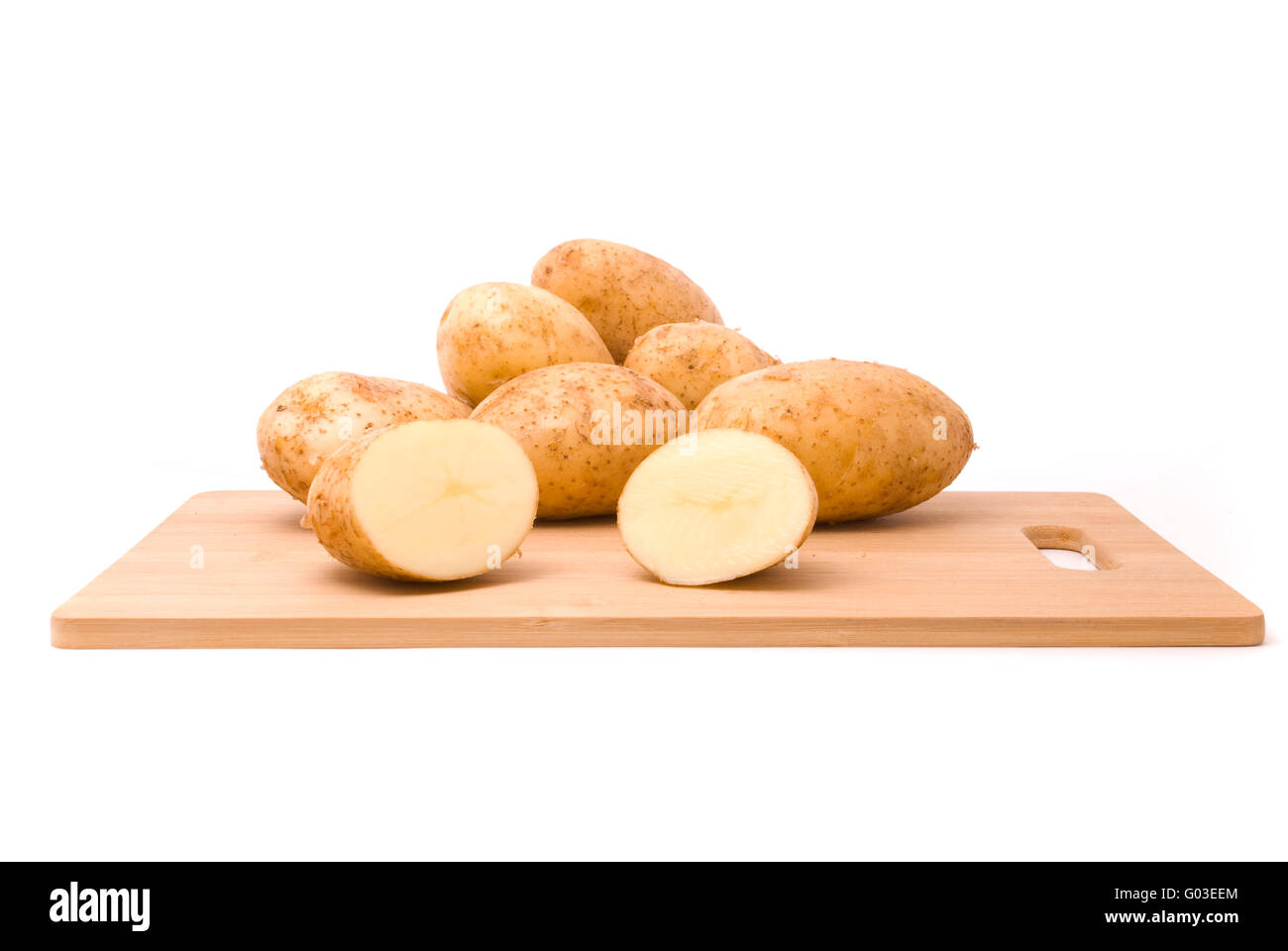 Frische Kartoffeln mit Brett auf einem weißen Hintergrund Stockfoto