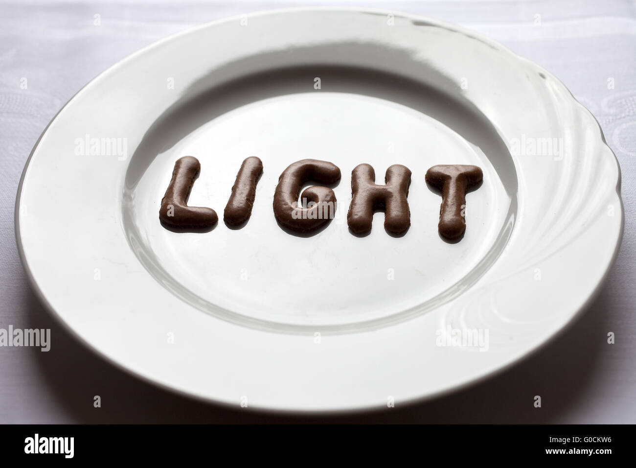 Buchstaben, das Wort Licht auf einem Teller Stockfoto