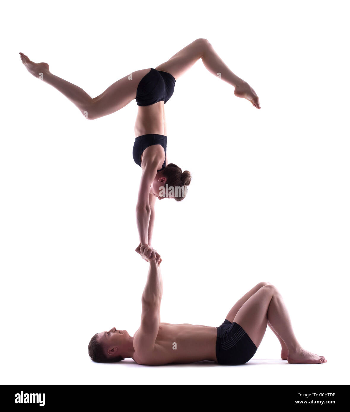 Zwei junge attraktive Akrobaten isoliert auf weiss Stockfoto