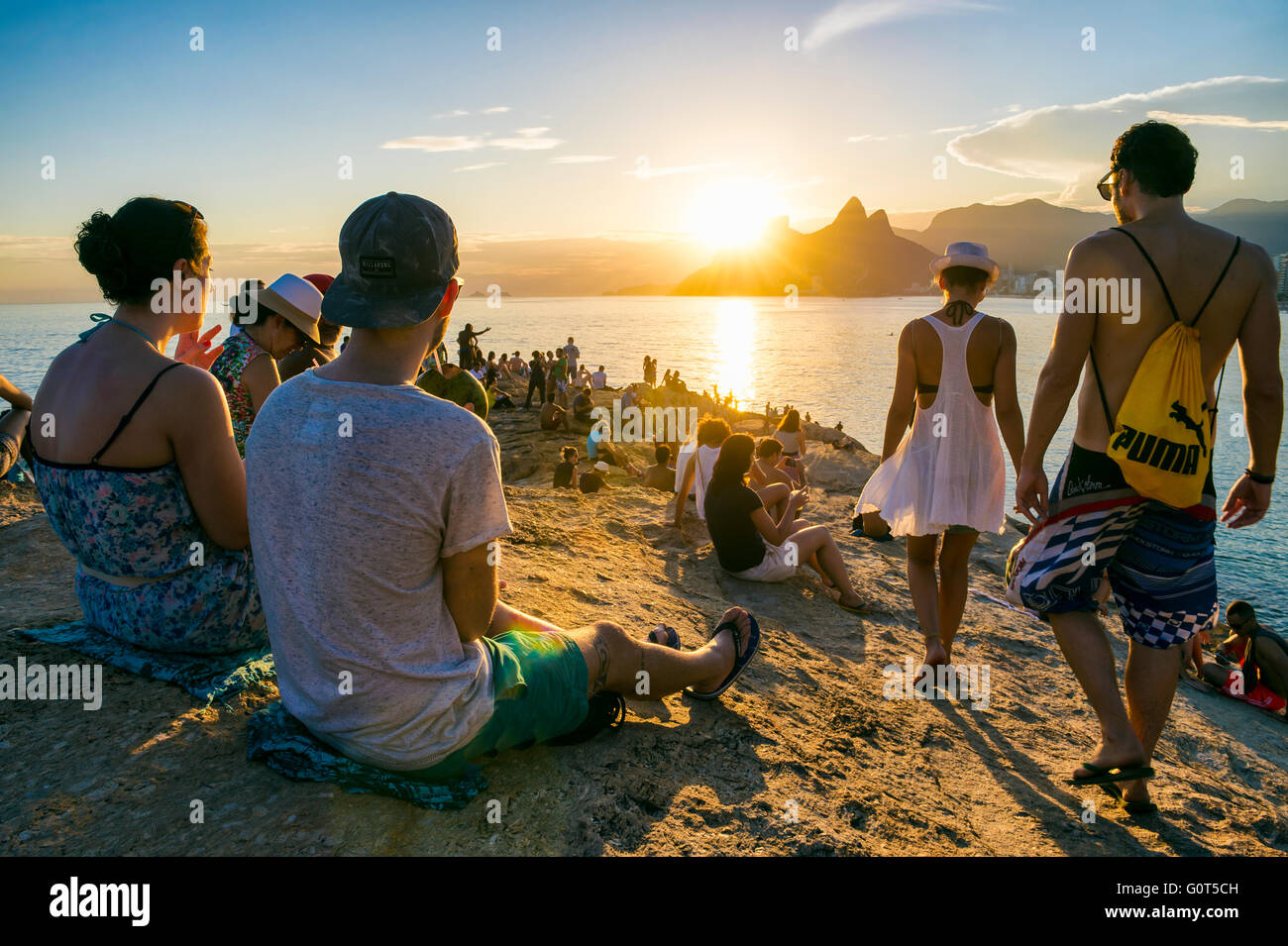 RIO DE JANEIRO - 26. Februar 2016: Massen von Menschen versammeln, um den Sonnenuntergang auf den Felsen am Arpoador in eine beliebte Tradition. Stockfoto