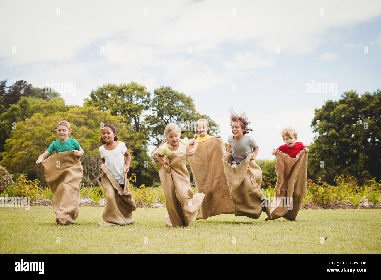 Kinder mit einem Sackhüpfen im park Stockfoto