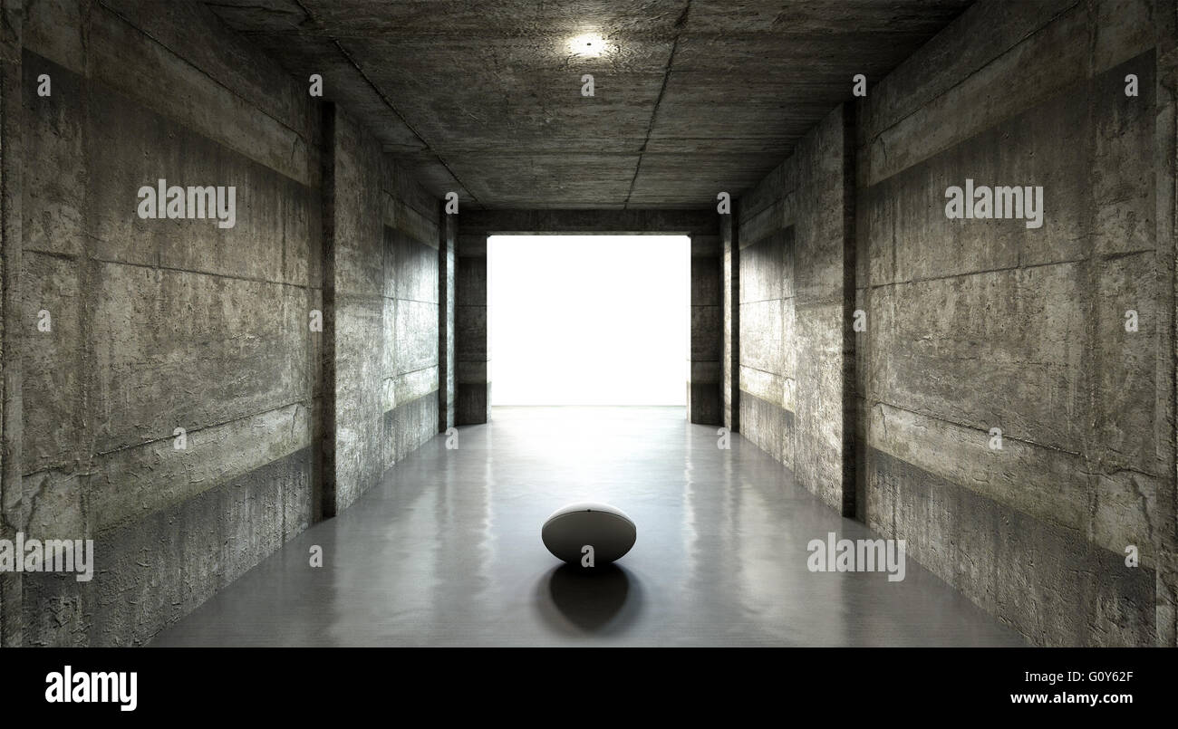 Ein entfernten Blick auf einen dunklen Stadion Tunnel auf eine beleuchteten Arena in der Ferne mit einem Rugby-Ball geben platziert am Eingang Stockfoto
