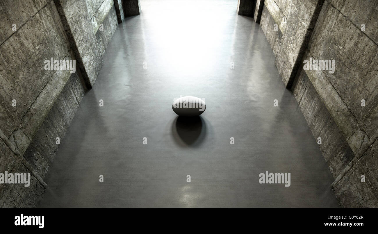 Ein entfernten Blick auf einen dunklen Stadion Tunnel auf eine beleuchteten Arena in der Ferne mit einem Rugby-Ball geben platziert am Eingang Stockfoto