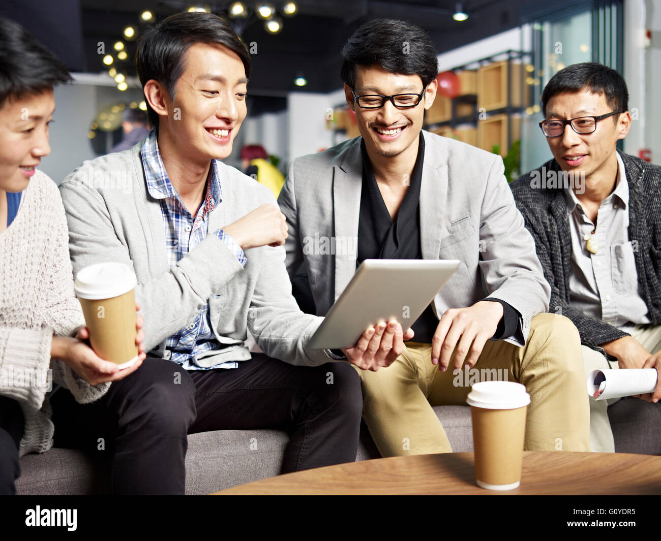 junge asiatische Geschäftsleute mit Tablet-PC Stockfoto