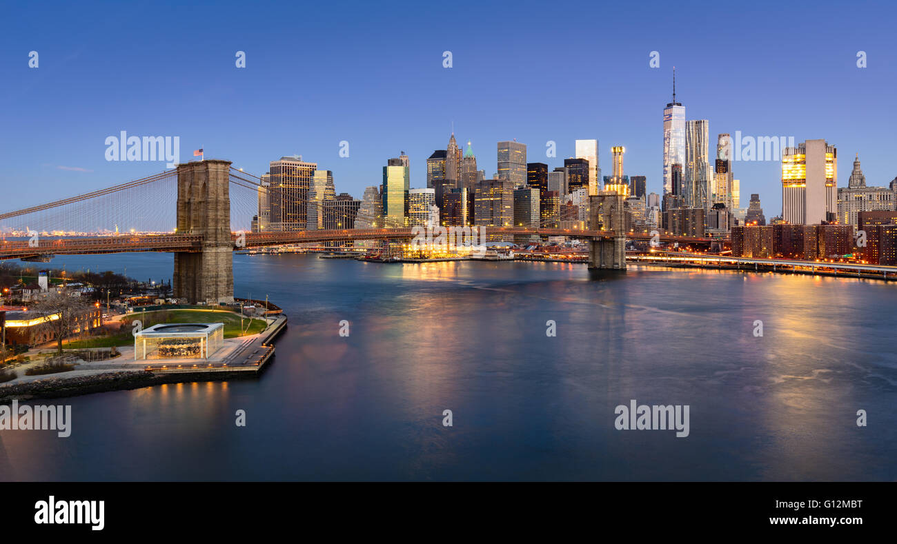 Blick auf die Brooklyn Bridge bei Sonnenaufgang mit Manhattan Financial District Wolkenkratzern und dem East River. New York City Stockfoto