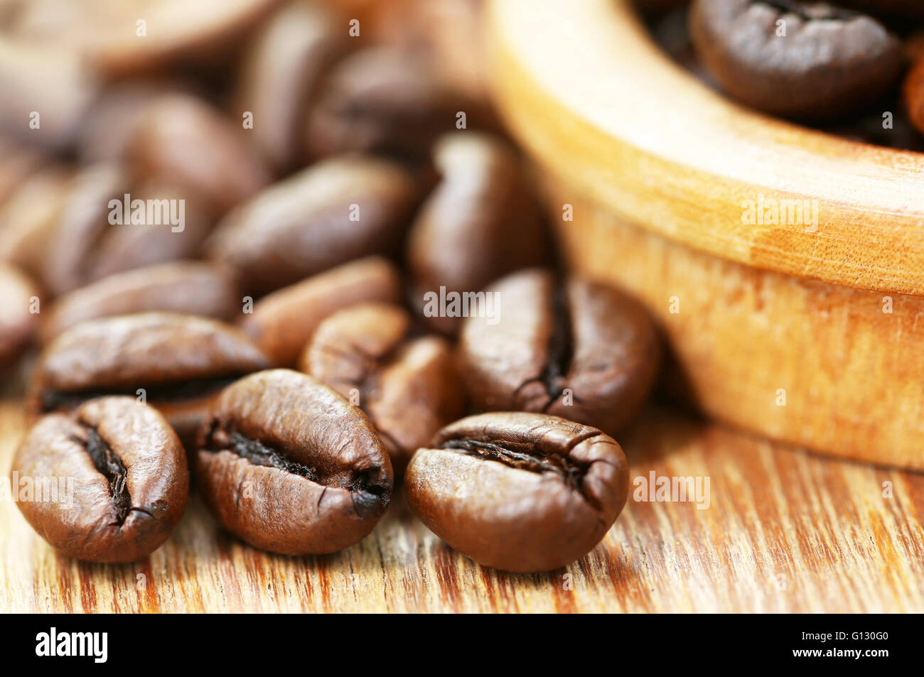 Geröstete Kaffeebohne in Holzoberfläche Stockfoto