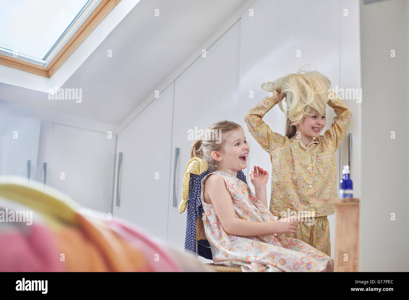 Mädchen spielen mit Perücke in Loft-Zimmer Stockfoto
