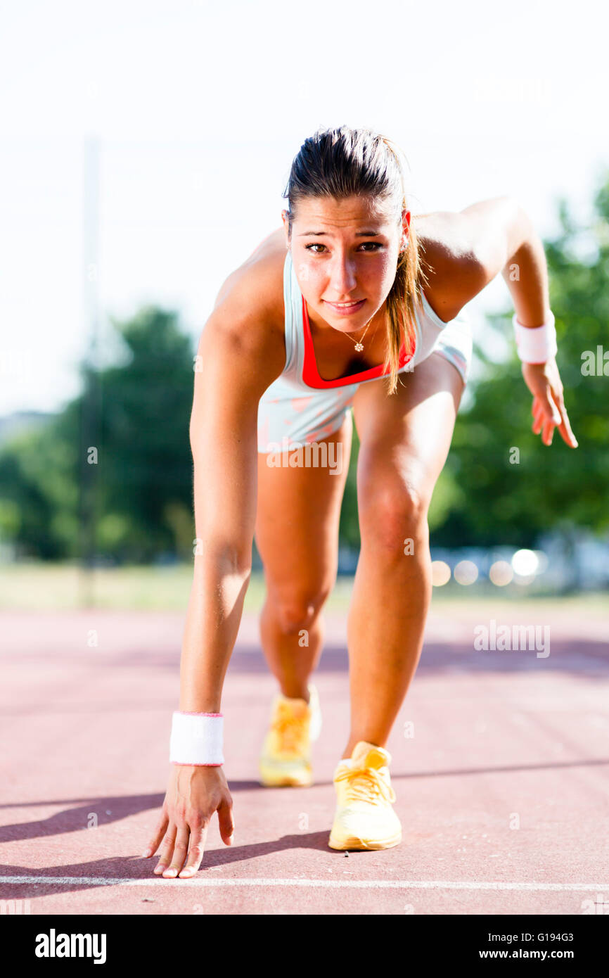 Schöne weibliche Sprinter immer bereit für den Lauf im Sommer Stockfoto
