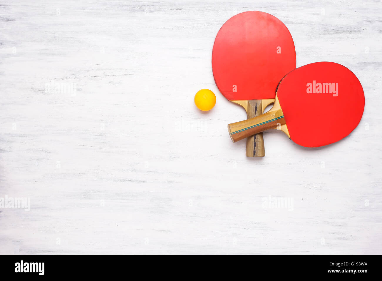 Zwei Tischtennis-Schläger auf einem weißen Holztisch. Draufsicht des Ping-Pong Paddel. Wettbewerb-Konzept. Stockfoto