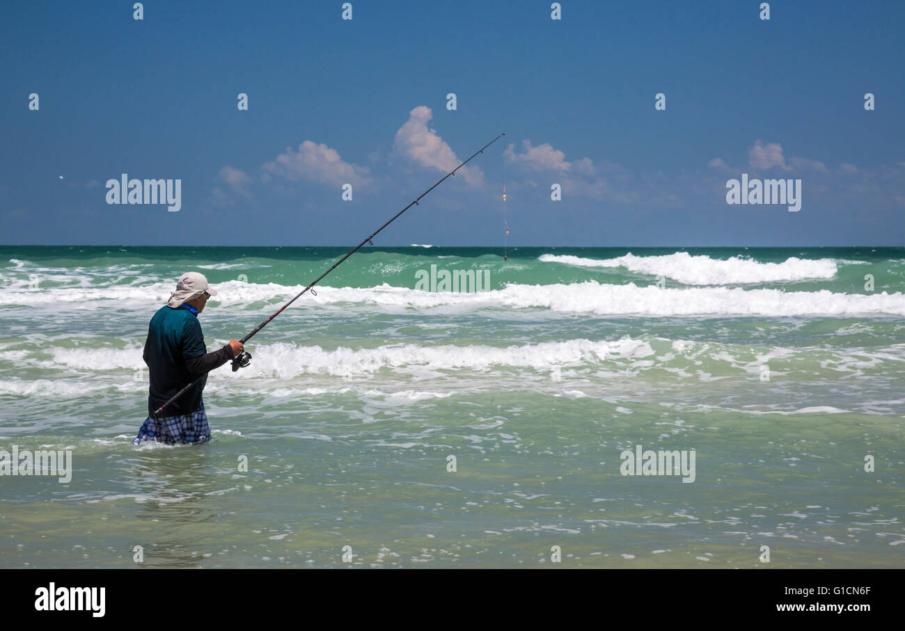 Titusville, Florida - ein Fischer in den Atlantischen Ozean Wellen im Canaveral National Seashore. Stockfoto
