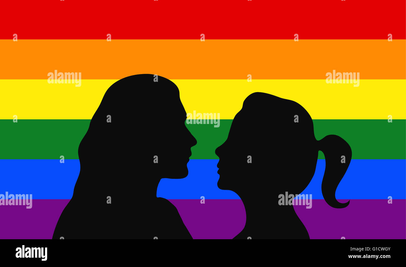 Lesbisches Paar vor der Regenbogen Flagge. Stockfoto