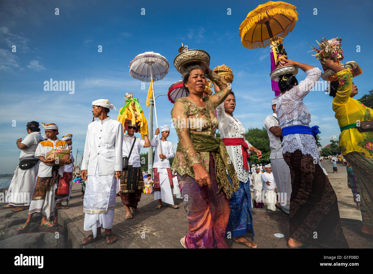 Männer und Frauen von den hinduistischen Balinesen glauben, die Teilnahme an einer Prozession bei der Melasti religiösen Zeremonie auf Bali Insel Stockfoto