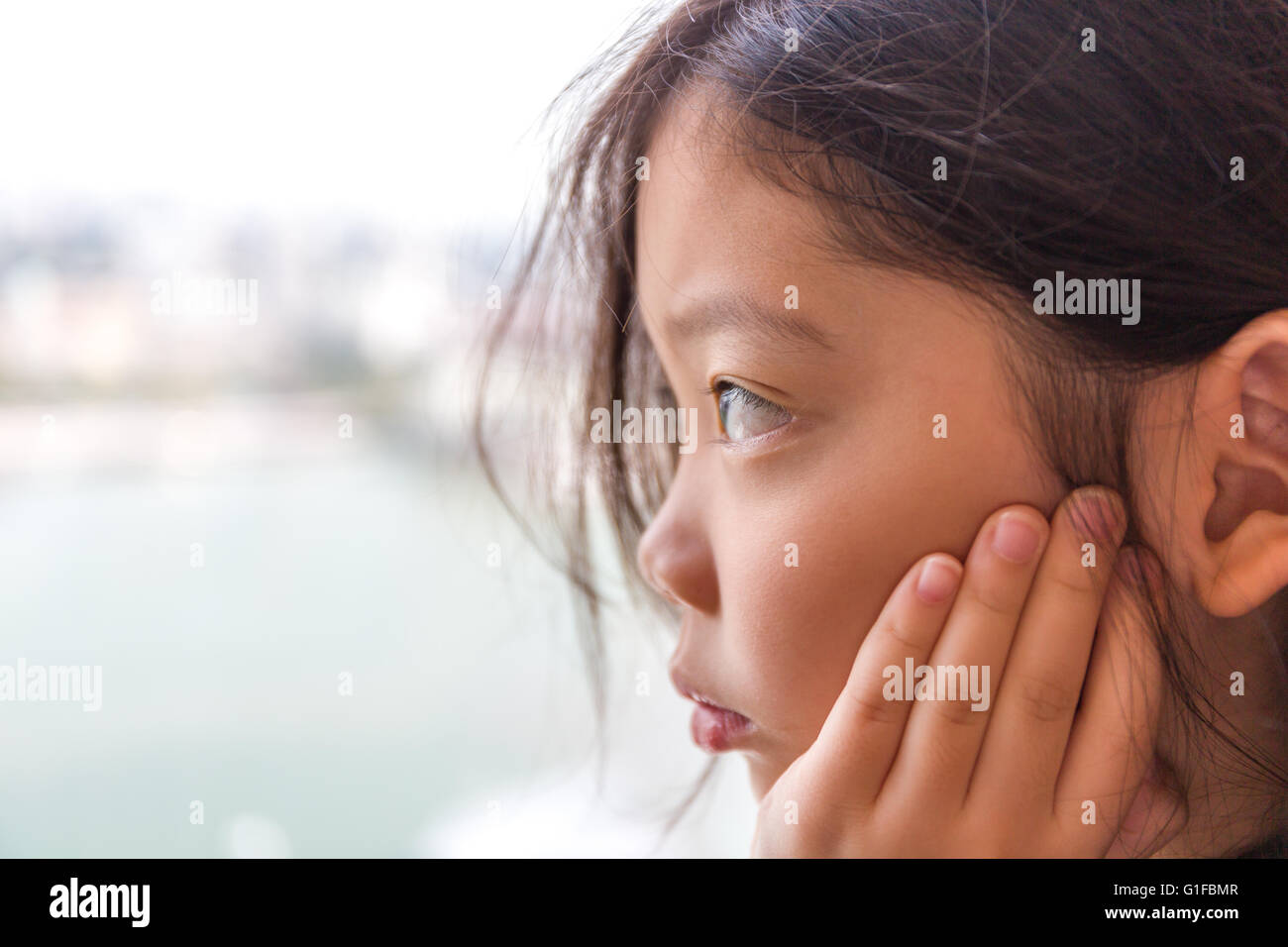 Trauriges Mädchen Blick aus Fenster wartet auf jemanden. Stockfoto