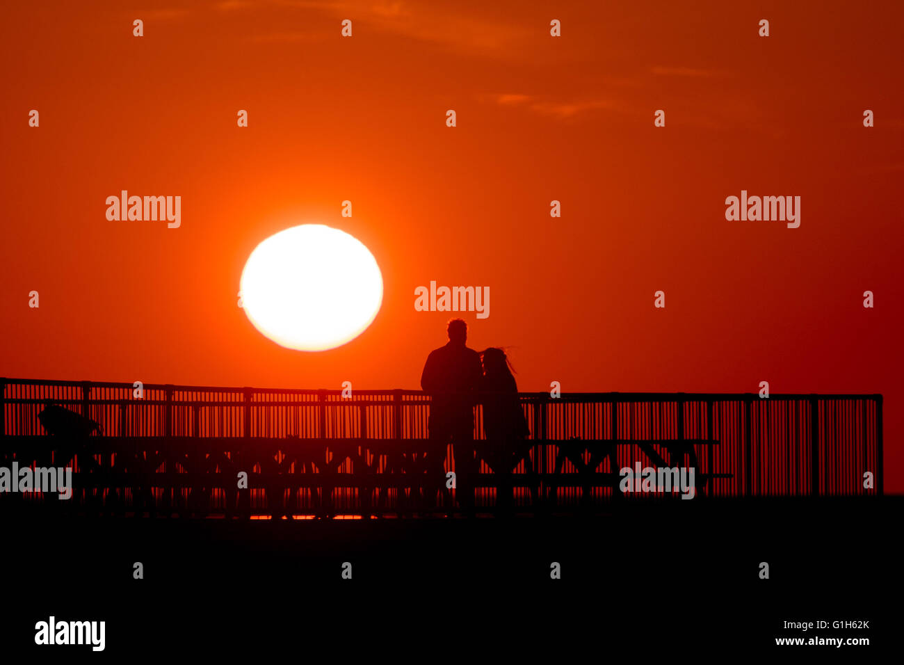 Aberystwyth, Wales UK Ceredigion, Sonntag, 15. Mai 2016 UK Wetter: einen spektakulären Sonnenuntergang über die Silhouette Zahlen von Menschen auf dem Pier in Aberystwyth an der Cardigan Bay Küste von Wales.   Das Wetter war hell, aber Kühler Vortagen, und die Prognose ist für verunsichert, windig und nass Wetter in aus dem Westen bis zur Mitte der Woche Foto Kredit zu verbreiten: Keith Morris / Alamy Live News Stockfoto