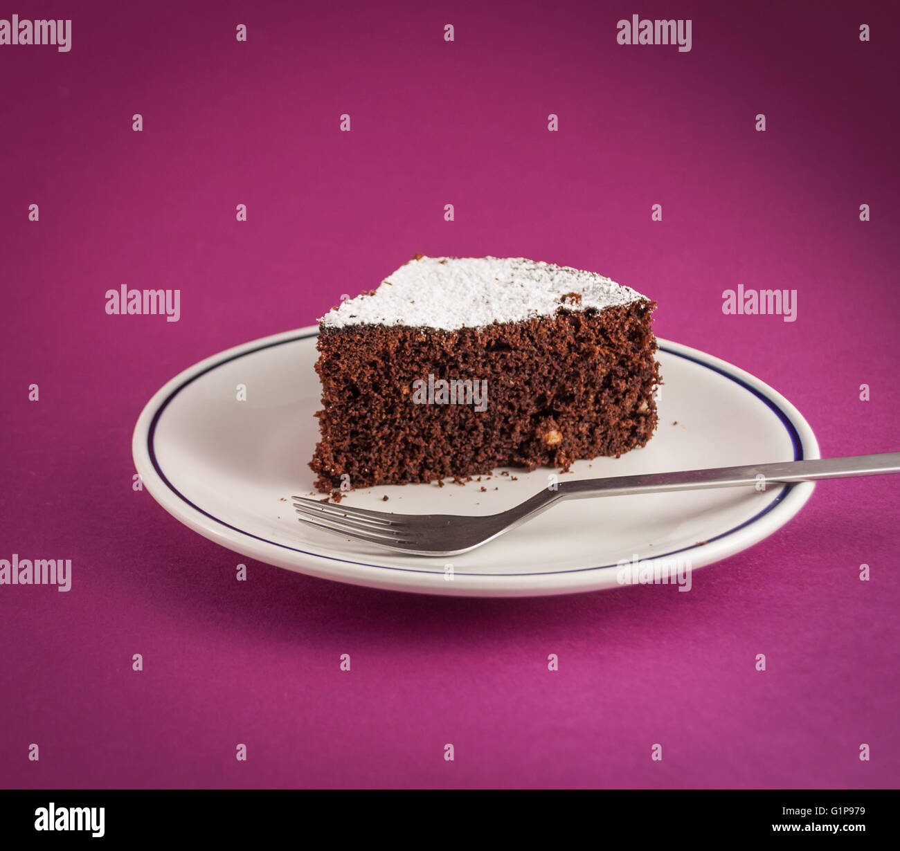 Nahaufnahme von Stück Schokoladenkuchen auf farbigem Hintergrund Stockfoto