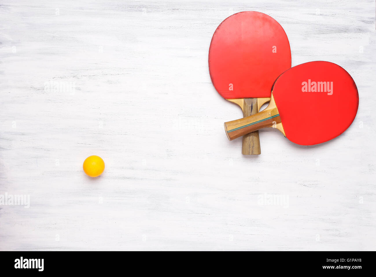 Zwei Tischtennis-Schläger auf einem weißen Holztisch. Draufsicht des Ping-Pong Paddel. Wettbewerb-Konzept. Stockfoto